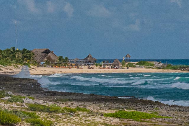 View of a beach restaurant in Cozumel with a big palapa hut